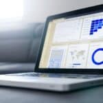 Sleek laptop showcasing data analytics and graphs on the screen in a bright room.