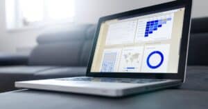 Sleek laptop showcasing data analytics and graphs on the screen in a bright room.