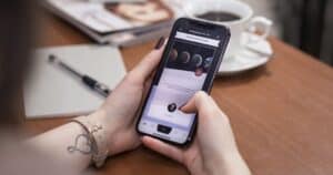 Small business owner checking mobile site display issues on smartphone